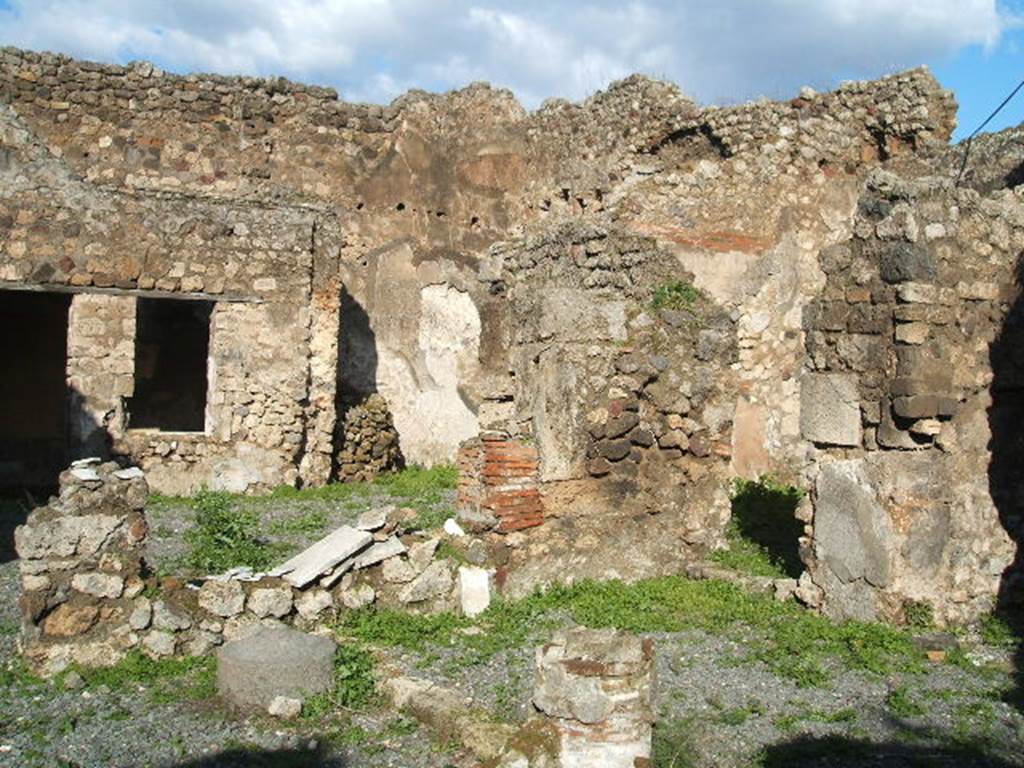 VII.12.26 Pompeii. December 2004. Looking north-east across portico area to oecus in north-east corner.