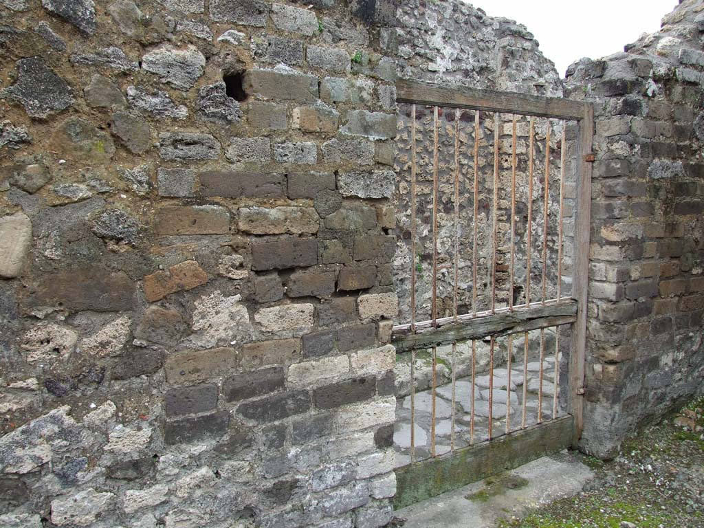 VII.14.5 Pompeii. March 2009. Room 18, kitchen and entrance doorway of VII.14.19, looking north-west.