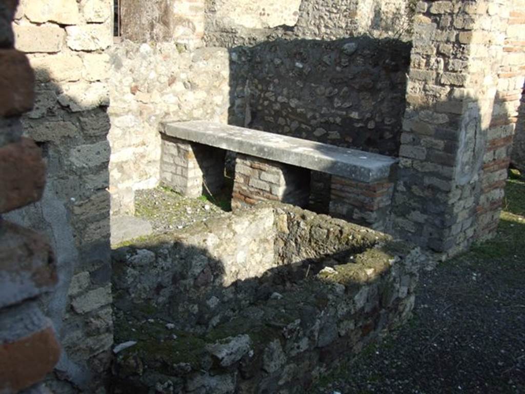 VII.14.18 Pompeii. December 2007. Looking east from entrance at basin and marble bench on north side.