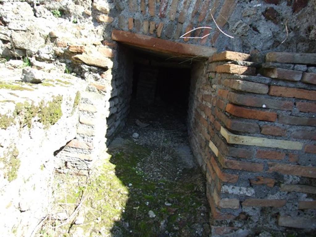 VII.15.2 Pompeii.  March 2009. Kitchen.  East wall.  Entrance to praefurnium for the caldarium which was stoked from the kitchen.