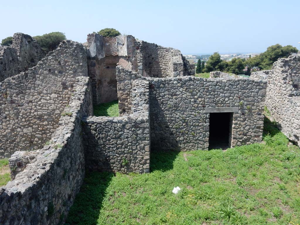 VII.16.1 Pompeii. June 2019. Looking west across courtyard in north-west corner and entrance to bath suite. Photo courtesy of Buzz Ferebee.