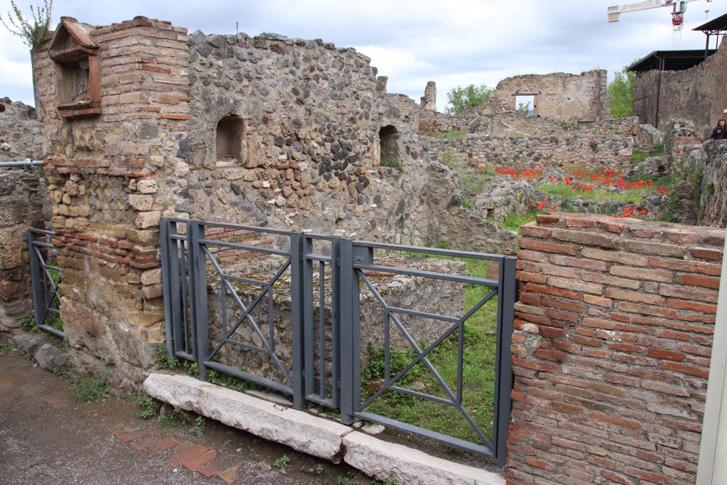 VII.16.7 Pompeii. May 2024. 
Entrance doorway, pilaster with aedicula niche and two niches on west wall of bar-room. Photo courtesy of Klaus Heese.
