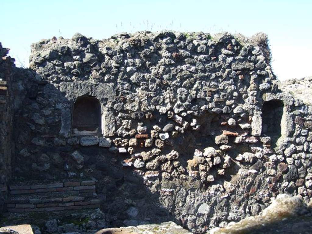 VII.16.7 Pompeii. March 2009. West wall with two arched niches. According to Boyce, these two arched niches, of similar size, were described by Fiorelli as “due nicchie per I Penati”.  See Boyce G. K., 1937. Corpus of the Lararia of Pompeii. Rome: MAAR 14. (p.73, no.337) 
