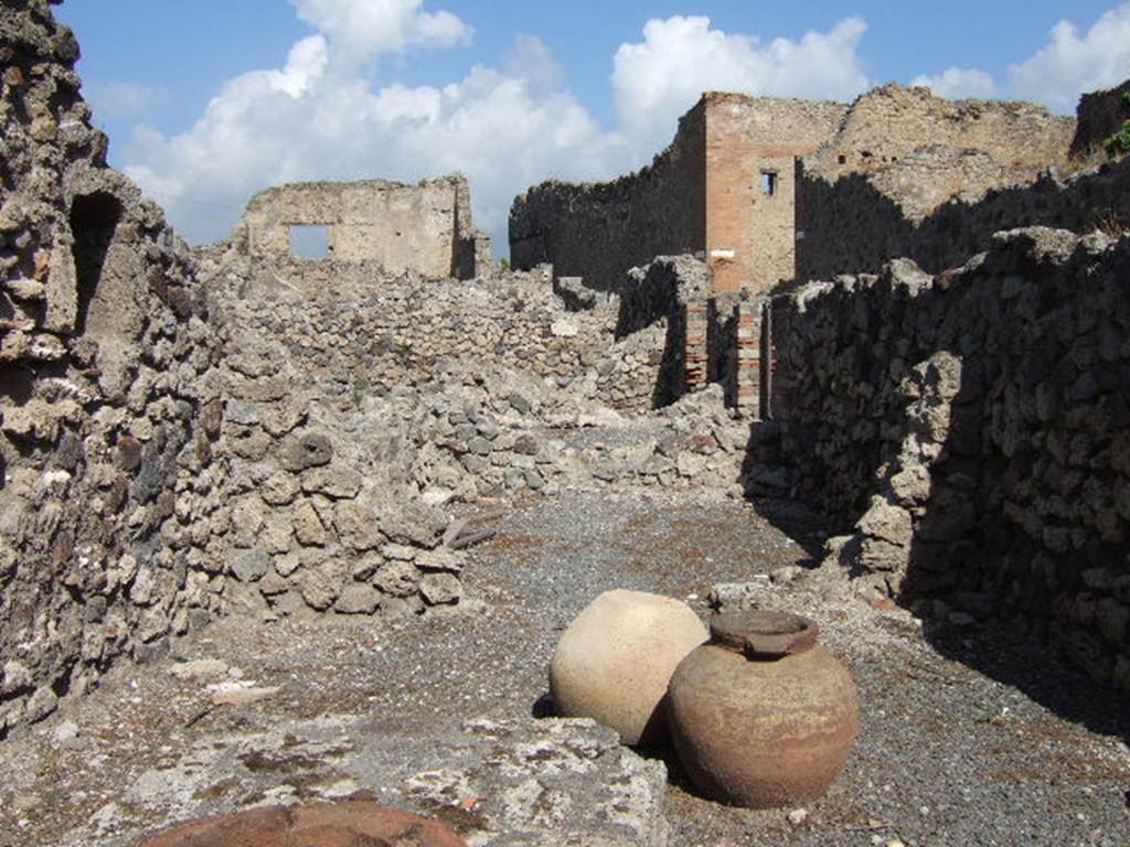 VII.16.7 Pompeii. September 2005. Looking north across bar-room to rear room.
