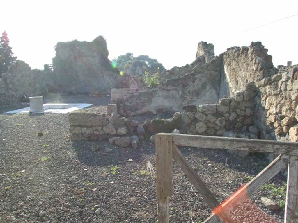 VII.16.11 Pompeii. December 2007. Looking west across shop, in foreground, with atrium and impluvium of VII.16.10, at rear.