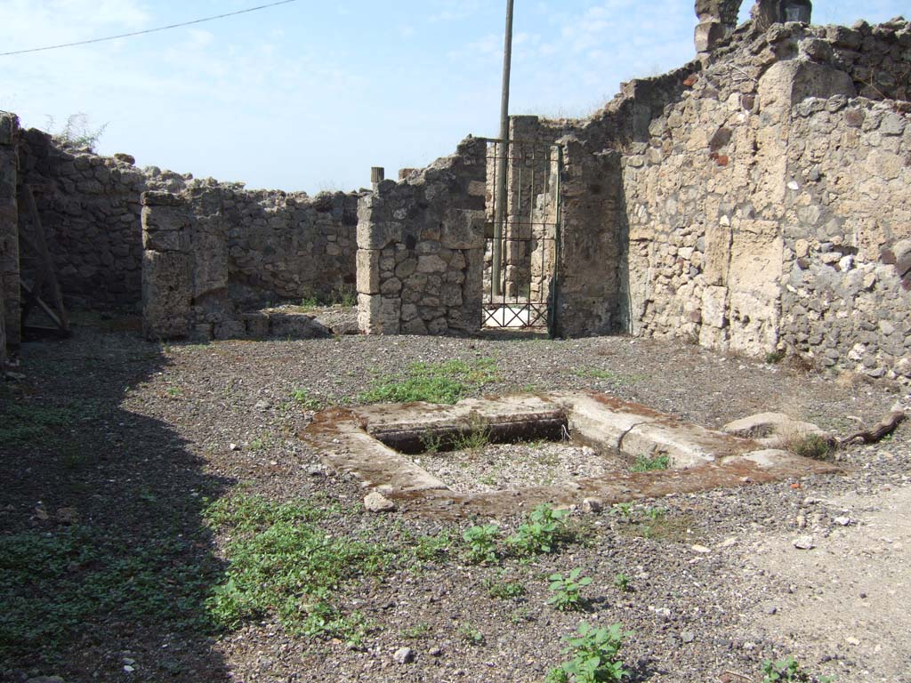 VII.16.12 Pompeii. September 2005. Room 24, looking west across atrium.
At the rear of the atrium are two rooms. On the left is room 26 which was a cubiculum.
In the centre is room 25, a closed tablinum.
On the right is area 27, with entry to lower rooms.
On the left side of the atrium, according to Eschebach, there would have been steps to the upper floor.
See Eschebach, L., 1993. Gebäudeverzeichnis und Stadtplan der antiken Stadt Pompeji. Köln: Böhlau. (p. 348).