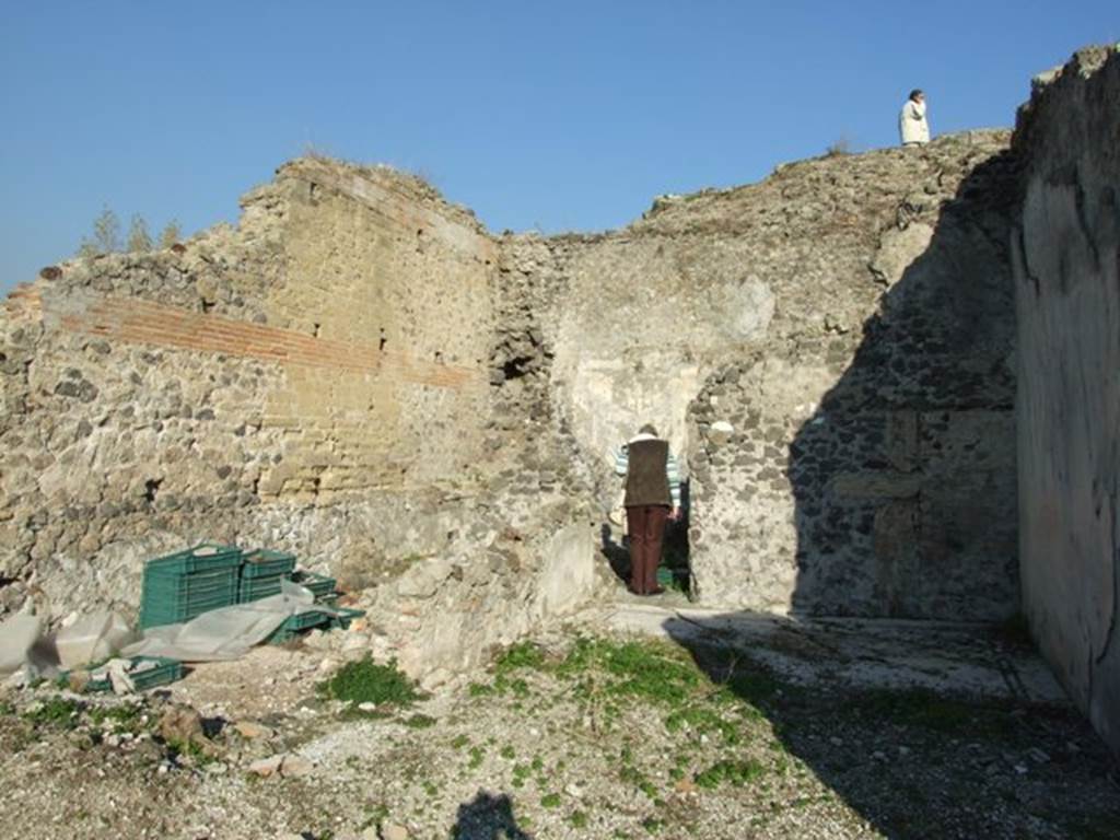VII.16.13 Pompeii. December 2007. Looking east across room 33 to doorway into room 35, not photographed, Room 35 had a doorway in its south wall to room 36. It also had another doorway in its north-west corner which led into room 34. Room 34 is the area on left of photo with the green crates.