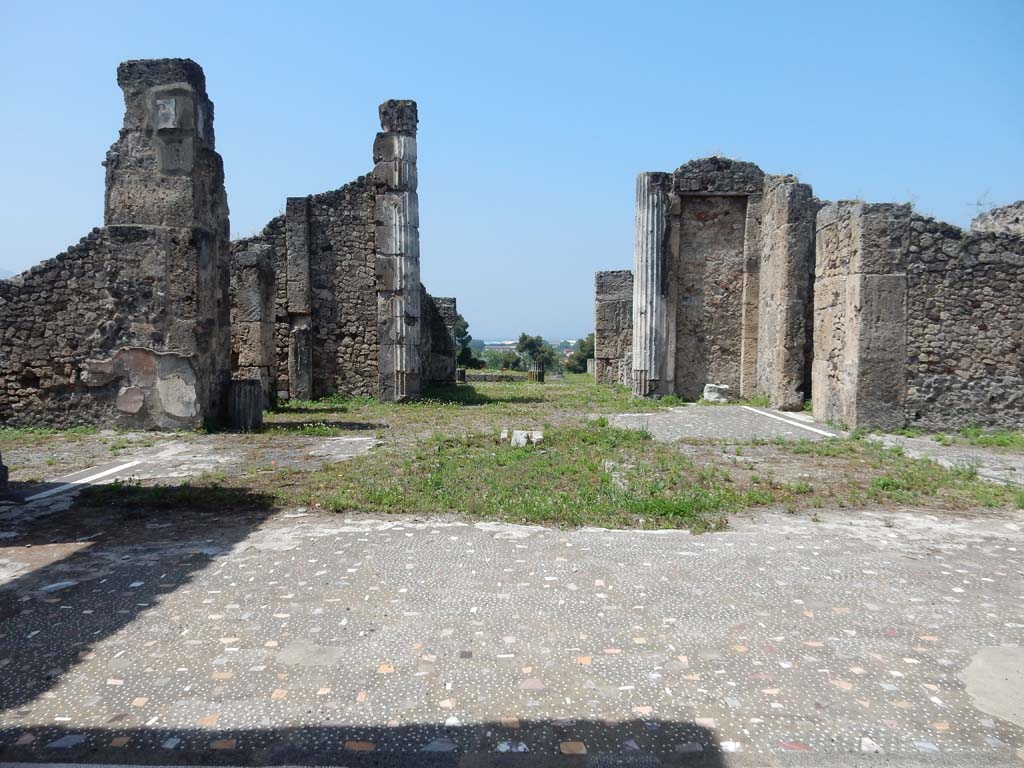 VII.16.13 Pompeii. June 2019. Looking west across atrium 2, towards tablinum 9. Photo courtesy of Buzz Ferebee.
According to Fiorelli –
“Il tablino, che sta di fronte allo ingresso, tiene ai lati due oeci, i cui aditi dall’atrio furono anticamente murati:e succede ad esso un grandioso peristilio, contenente un’ampia piscina, con piu stanze nei lati, e con spaziosi loggiati che si prolungavano sulle pubbliche mura.”
See Pappalardo, U., 2001. La Descrizione di Pompei per Giuseppe Fiorelli (1875). Napoli: Massa Editore. (p.161).
(translation: “"The tablinum which stands facing the entrance doorway, had two reception rooms (oeci) on its sides, whose doorways to the atrium were formerly walled up in antiquity: and following on was a large peristyle containing a large pool, with several rooms at the sides, and with spacious loggias that extended onto the public walls.")