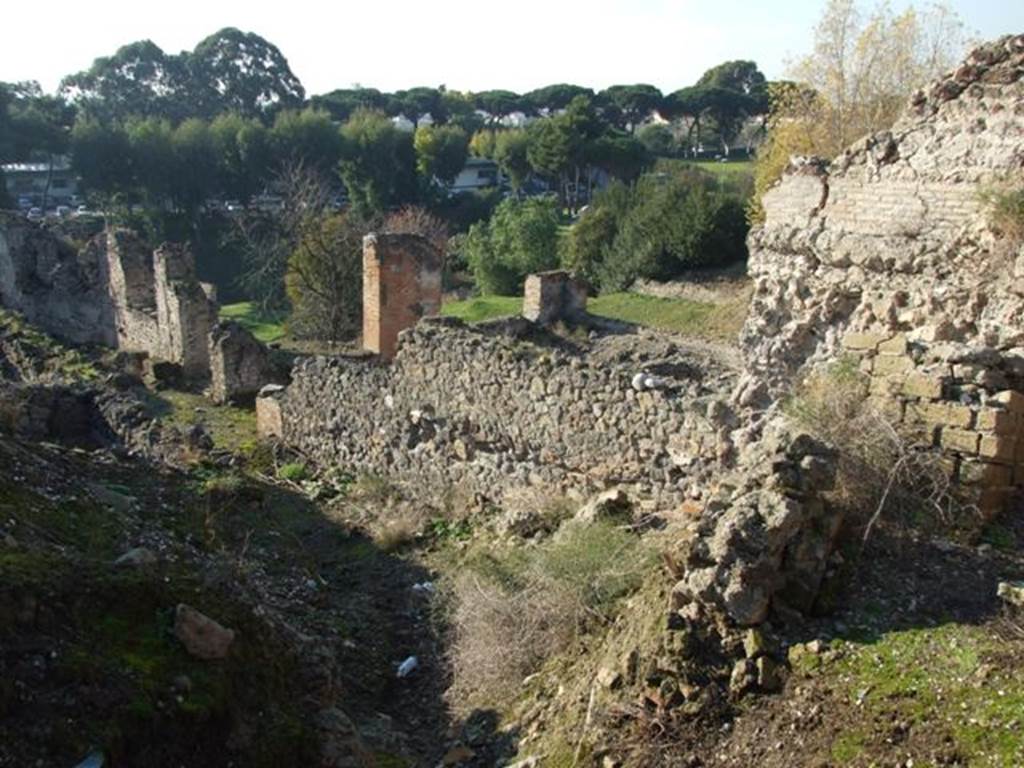 VII.16.16 Pompeii. September 2004. Looking north-west across rooms 15 and 16 towards room 18 with the brick pillars.