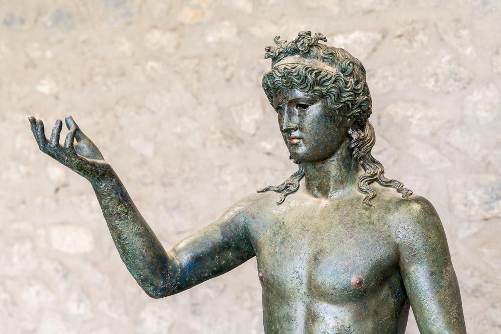 VII.16.17-22 Pompeii. January 2023. Bronze Ephebus, used as an oil lamp holder, found in oecus 62.
On display in exhibition in Palaestra. Photo courtesy of Johannes Eber.