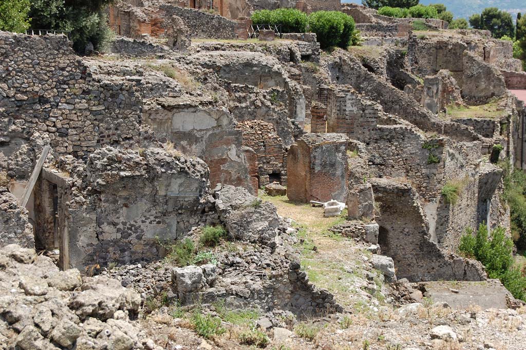 VIII.2.1/3 Pompeii. June 2010.
Looking across east from area of large room with vaulted ceiling on lower left.
At the rear of this room, centre of photo is the large triclinium “J”, with masonry remains belonging to the walls of rooms/terrace on its south side.
In the centre top of the photo, behind triclinium “J”, the remains of the vaulted ceiling of the large triclinium in VIII.2.3/VIII.2.16 can be seen.
In the upper right of the photo are the rooms belonging to the lower rear rooms of VIII.2.14-16.
Photo courtesy of Sandra Zanella.