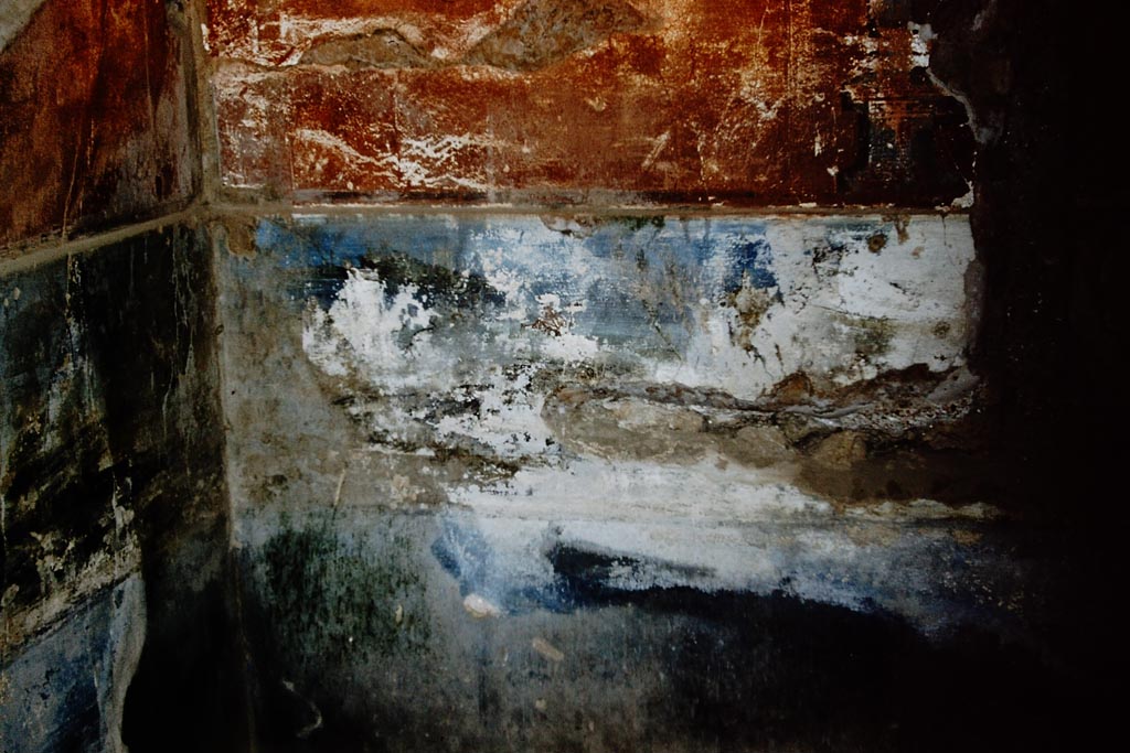 VIII.2.18 Pompeii. 1961. Frigidarium 54, the plunge pool on level 4, detail of remains of west end of north wall.
In the upper right is one of the pediment feet shown in the 1896 Niccolini painting.
The blueish band in the middle is the western half of the landscape panel.
Photo by Stanley A. Jashemski.
Source: The Wilhelmina and Stanley A. Jashemski archive in the University of Maryland Library, Special Collections (See collection page) and made available under the Creative Commons Attribution-Non-Commercial License v.4. See Licence and use details.
J61f0805