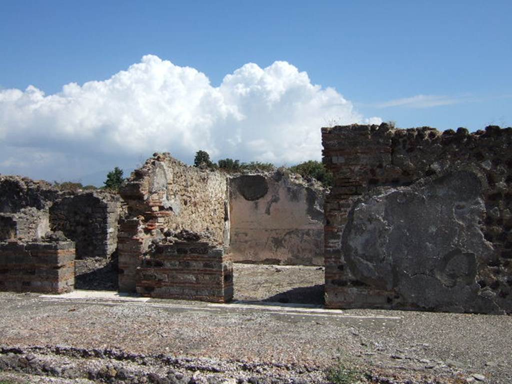 VIII.2.26 Pompeii. September 2005. East side of the atrium, with doorways to services area ‘h’,  and cubiculum ‘L’. When excavated the floor of cocciopesto of cubiculum ‘L’ was found to be of excellent quality with a combination of octagons and stars. In the centre of the octagons were white crosses containing black central tesserae.
