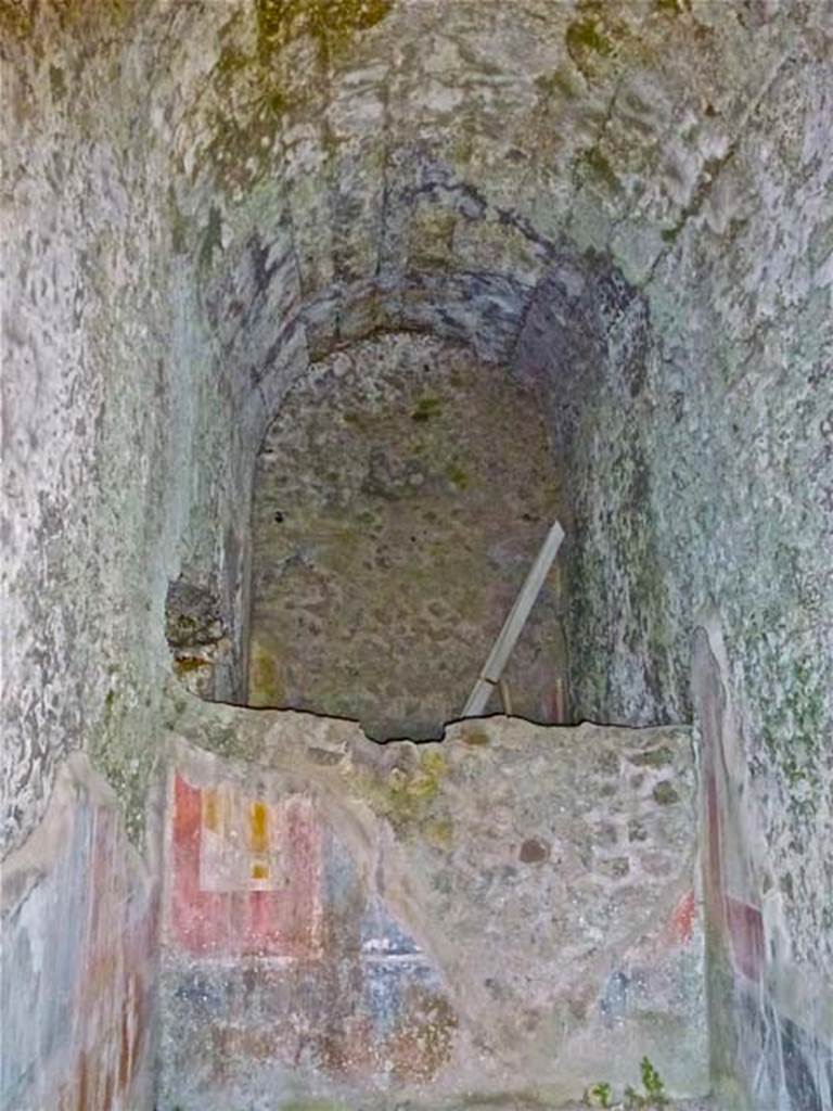 VIII.2.26 Pompeii. September 2011. Painted decoration on north wall of cubiculum.
According to Allison, this cubiculum had a wide opening from the corridor on its south side.
The walls were decorated in the 4th Style with a black dado (zoccolo) with panels and flowers. In the central zone were red and black fields with central aediculae and architectural openings. The floor was of white mosaic with black borders.
See Allison, P.M., www.stoa.org/projects/ph/rooms?houseid=25