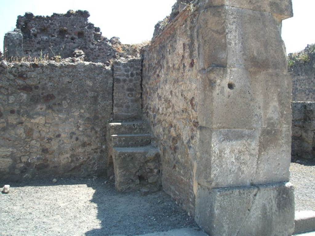VIII.4.14 Pompeii. May 2005. West side of shop with reconstructed steps to upper floor.