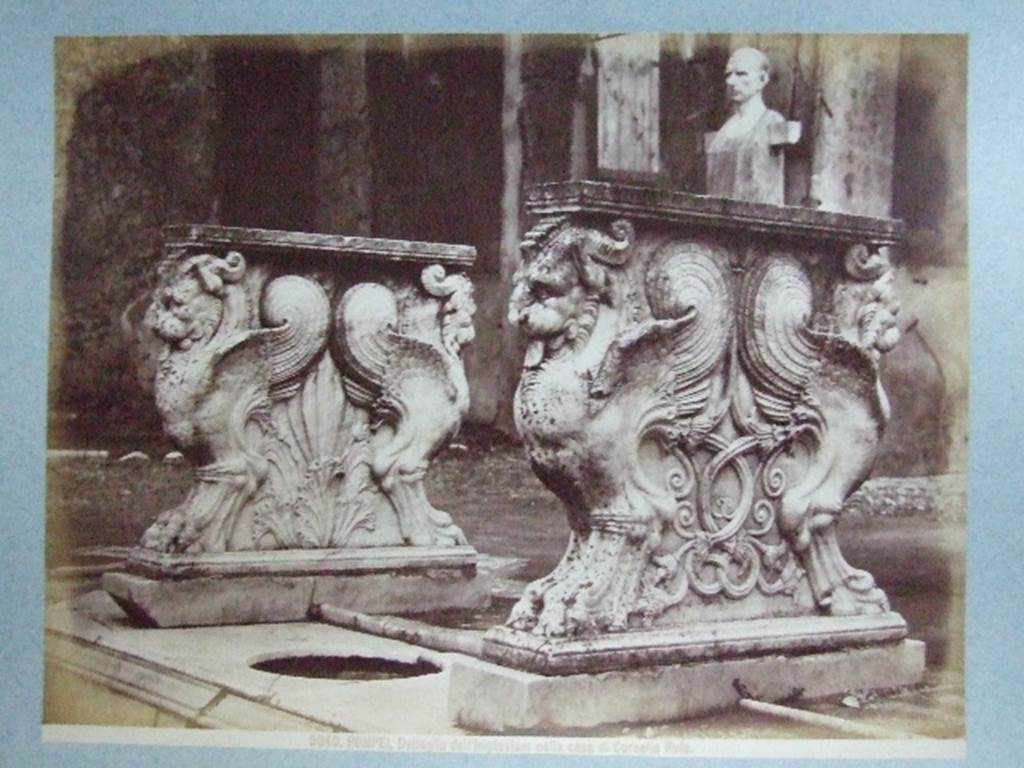VIII.4.15 Pompeii.  Supports of marble table or cartibulum. Bust and herm of C Cornelio Rufo – are in background. Undated photograph. Courtesy of Society of Antiquaries. Fox Collection.
