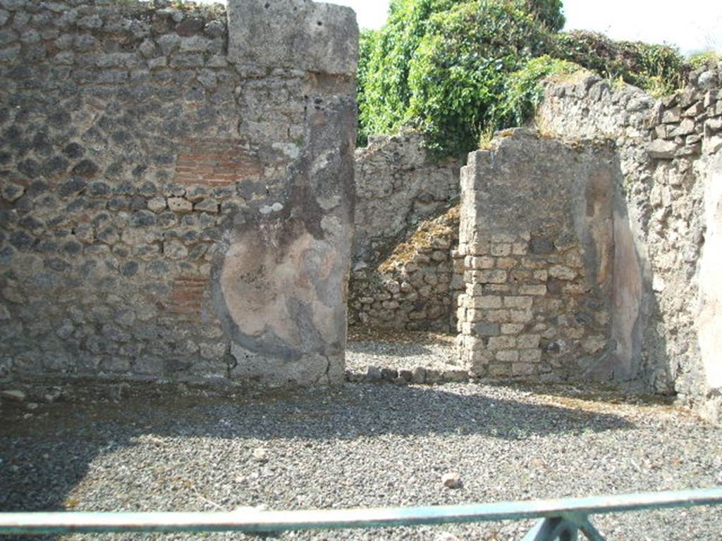 VIII.5.8 Pompeii.  Shop.  May 2005.  South wall with door to room containing stairs to upper floor.