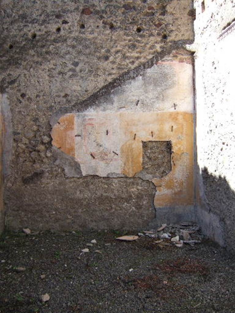 VIII.5.39 Pompeii. September 2005. Room 5, west wall.
According to PPM – The IV Style decoration is better preserved on this wall.
The central panel was white, the side panels were yellow edged with a border of “carpet” design;
the one on the right (north end) contained a medallion showing the head of a young girl – now taken off
The zoccolo would have been black with painted plants.
See Carratelli, G. P., 1990-2003. Pompei: Pitture e Mosaici: Vol. VIII. Roma: Istituto della enciclopedia italiana, p. 659.