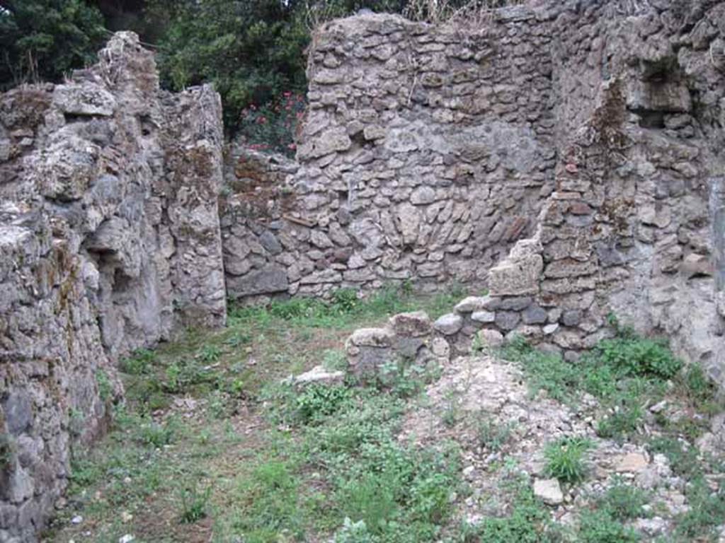 VIII.7.6 Pompeii. September 2010. Remains of west wall of “rustic” room, looking west into rear room, possibly kitchen. Photo courtesy of Drew Baker.
