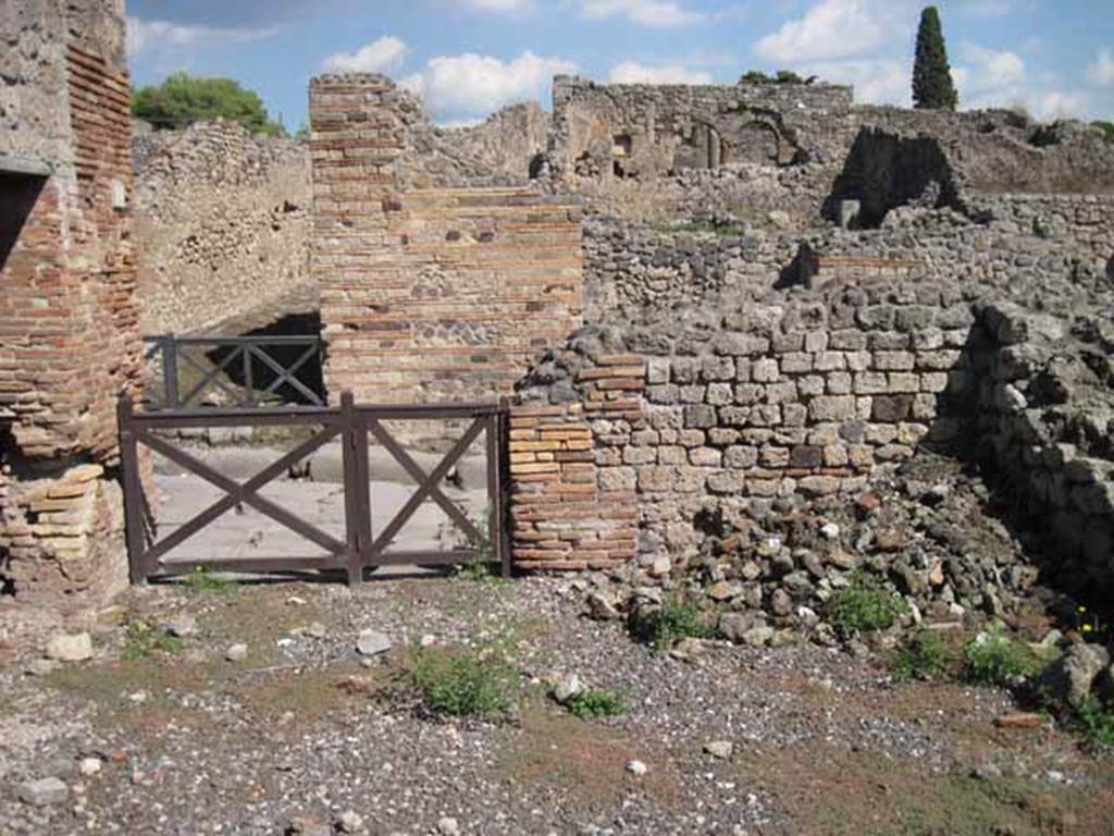 VIII.7.23 Pompeii. September 2010. East wall of shop and entrance doorway, looking east onto Via Stabiana. Photo courtesy of Drew Baker.
