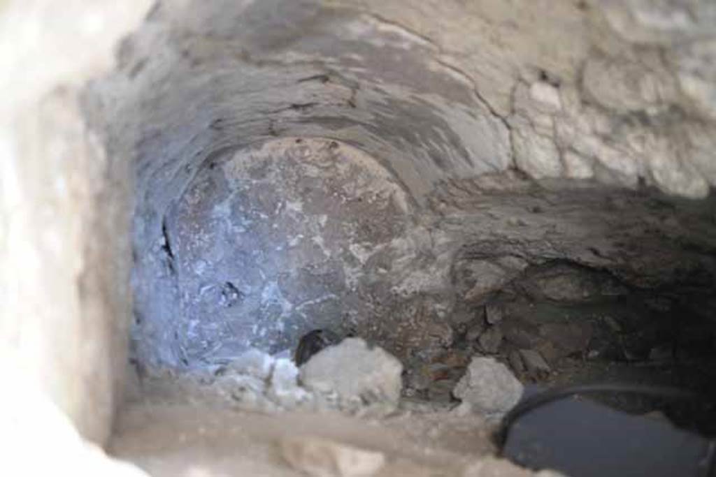 VIII.7.24 Pompeii. October 2010. Looking west into a vaulted room, half filled with debris. This room was leading west off of storage room and situated under the steps to the upper level. Photo and information courtesy of Drew Baker/Gareth Beale/Hembo Pagi.
