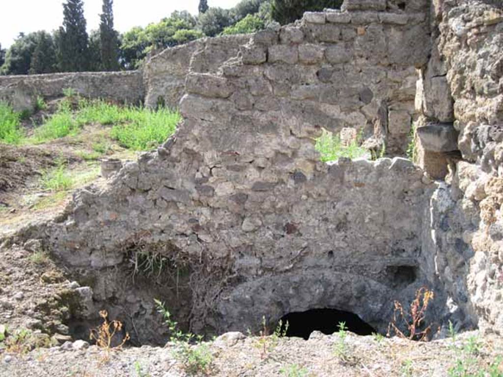 VIII.7.24 Pompeii. September 2010. Excavation on west wall (north-west corner) of northern portico looking west. Photo courtesy of Drew Baker.
