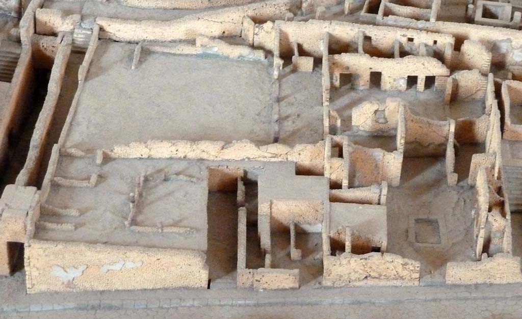 VIII.7.22-24, Pompeii. c. 1879. Looking west across Via Stabiana towards entrance doorway VIII.7.24, on right. 
VIII.7.26 is the peristyle and house at the top of the photo.
Detail from the Pompeii cork model in Naples Museum.
