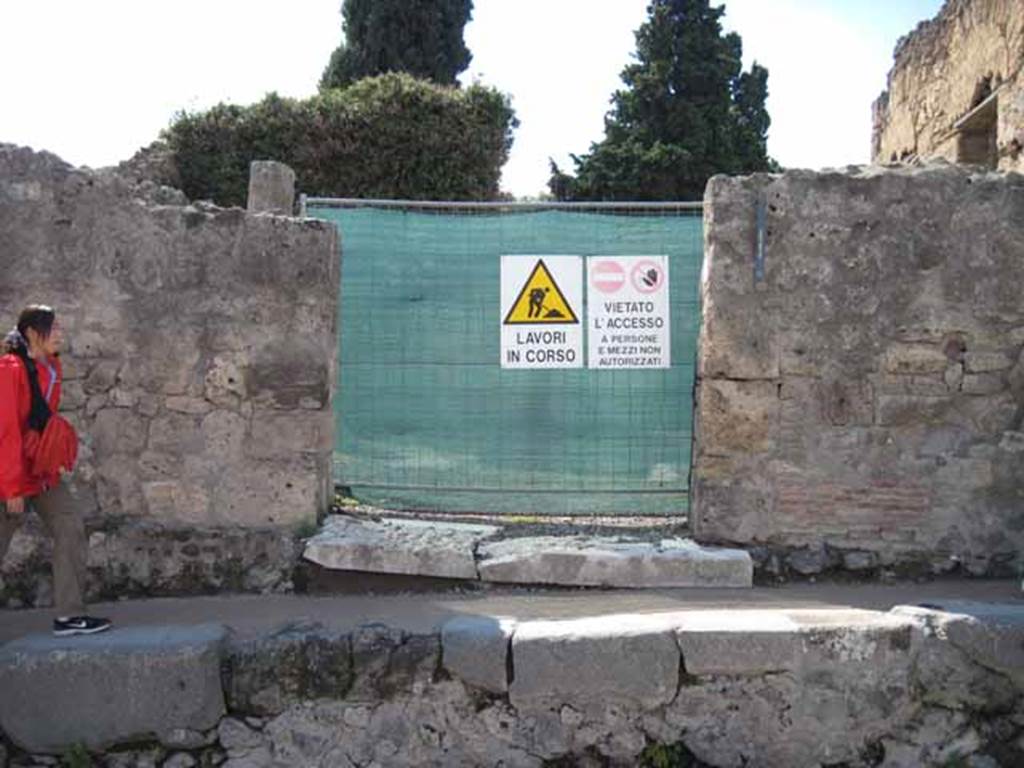 VIII.7.24 Pompeii. September 2010. Entrance, looking west.  Photo courtesy of Drew Baker.
This house is a little confusing as it is split into two levels. The entrance level consisted of atrium and surrounding rooms, probably used as the sculptors workshop. Fifteen steps led up to the upper part being the dwelling area, including the garden area surrounded by portico on four sides, a triclinium, cubiculi, another kitchen, and perhaps an exedra. Below the upper part would have been the areas of VIII.7.22 and 23. According to Fiorelli, the house was of very ancient construction but transformed into a workshop. This entire area is now very ruined.
According to Cooke Cockburn & Donaldson, the sculptors residence was one of the most interesting discoveries of the city. Found in it were statues of marble, some merely begun, others half-finished; with blocks of marble for other statues, and all the tools necessary for the artist. Among these, thirty-two mallets, many compasses, curved and straight, an infinity of chisels, three or four levers and jacks for raising blocks, saws, etc.
See Cooke Cockburn Donaldson, Pompeii, pt.1, 1827, (p.47)

