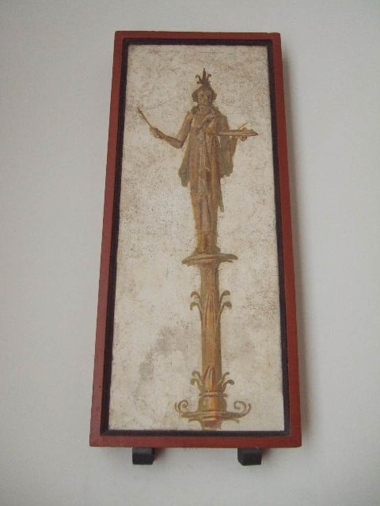 VIII.7.28 Pompeii.  Priestess on a candelabrum carrying offerings on a tray.  
Found in passageway of arch.  Now in Naples Archaeological Museum.
