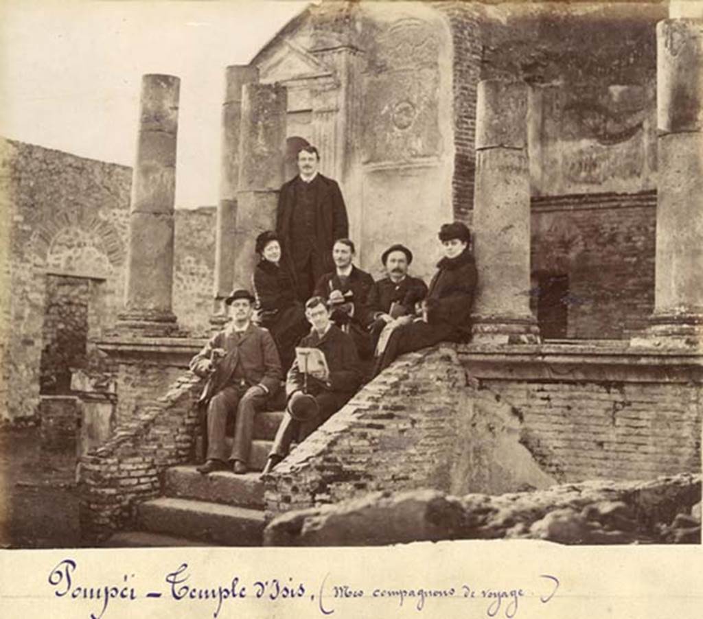 VIII.7.28 Pompeii. Old undated photograph, possibly c.1875 to early 1880s. Photo courtesy of Rick Bauer.
The man in front is holding a book, a copy of the Scafati Guide to Pompeii.  
Looking at the higher resolution original photo, the cover of the booklet has an image of the first cast that Fiorelli made in 1863.
It also has a curved top line of type above the word Pompei and has no binding on the spine.
These would date the booklet to the original editions which first came out in 1875.  
Based on a comparison with copies of the Scafati guide which Rick has in his private collection, the cover in the photo matches the first edition of the guide book.  
As such, he estimates the photo was taken sometime from 1875 to early 1880s. 
