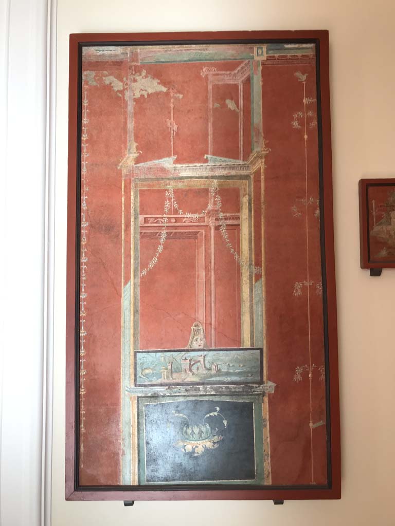 VIII.7.28 Pompeii. April 2019. Ultimate panel on the right of the east wall.
Architectural scene with Nilotic painting surmounted by a mask. 
Now in Naples Archaeological Museum. Inventory number 8539. Photo courtesy of Rick Bauer.
