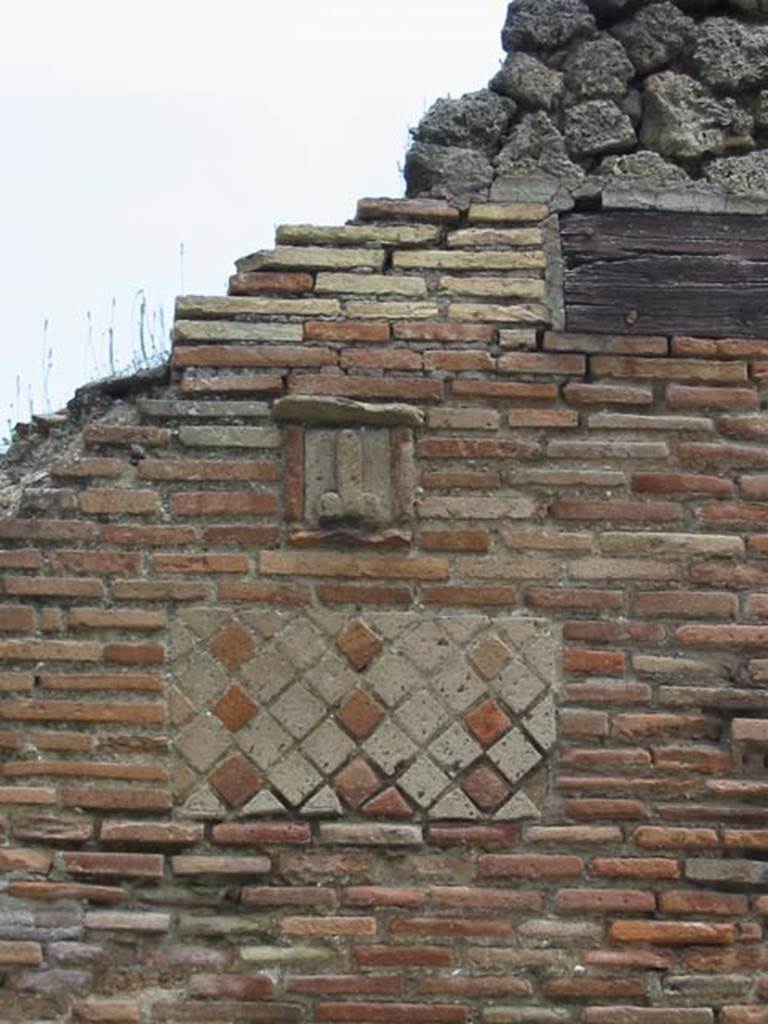 Wall with plaque between IX.1.13 and IX.1.14. May 2003. Photo courtesy of Nicolas Monteix.