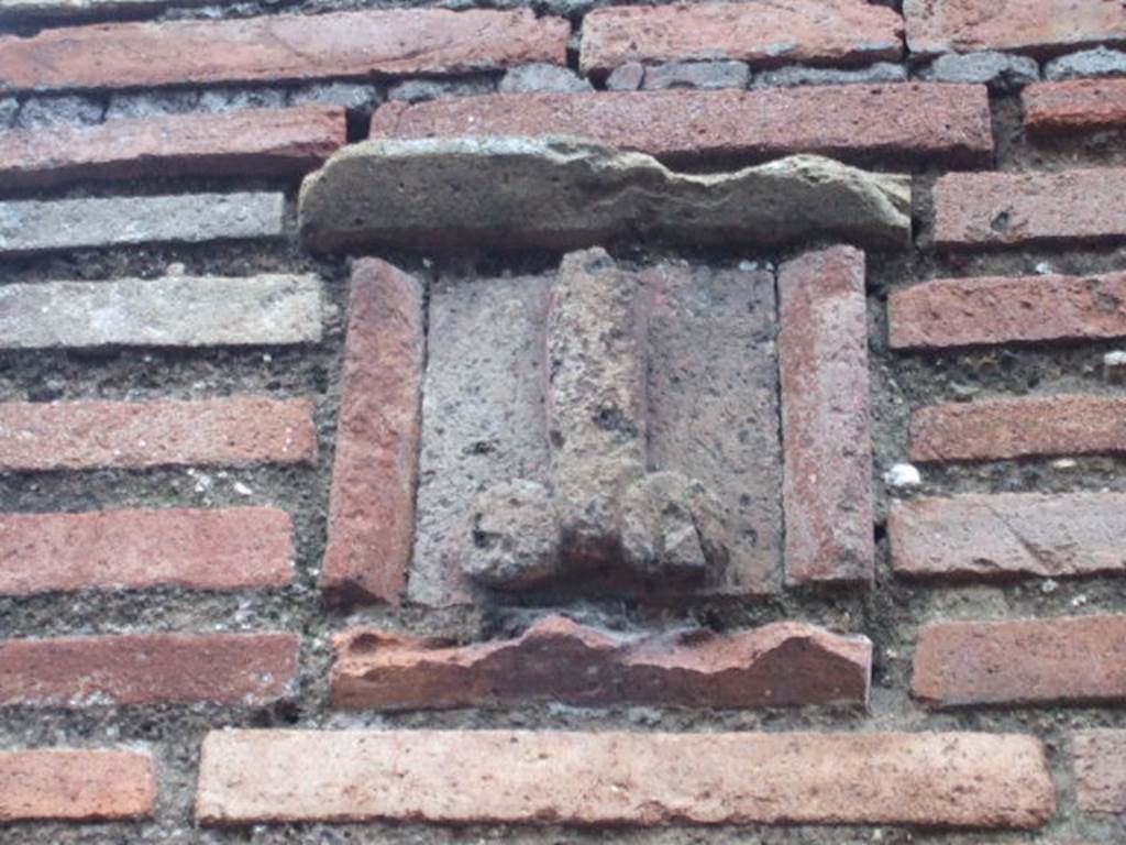 Plaque between IX.1.13 and IX.1.14. December 2005. According to Gallo, the sign on the façade showing a tufa phallus was the only merit of this shop.
The plaque, originally painted azure blue, shows an erect phallus with appendices painted in red, with an inscription painted in red below:
Ubi me iuvat, asido (CIL IV, 950)
According to Varone, this translates at “When it suits me, I sit on it”
(Asido is written instead of assido)
See Varone, A., 2002. Erotica Pompeiana: Love Inscriptions on the Walls of Pompeii, Rome: L’erma di Bretschneider. (p.90)
See Gallo, A: L’insula I della Regione IX, Settore Occidentale, in Studi della Soprintendenza archeologica di Pompei, no. I, 2001, (p.53)