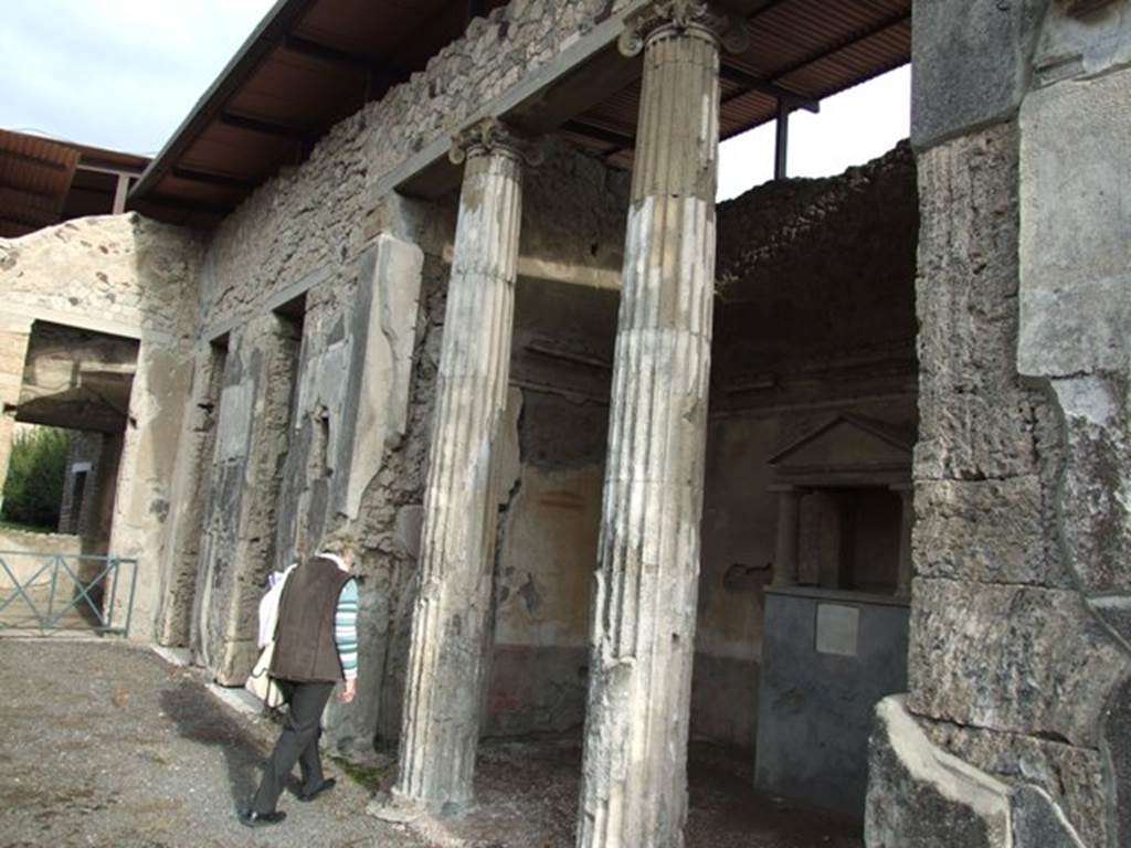 IX.1.20 Pompeii. December 2007. Room 2, atrium on east side, showing room 6, ala, with household shrine and 2 Ionic columns in opening.
