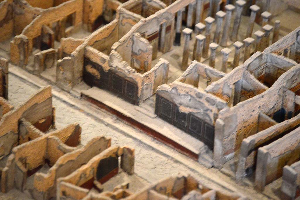 IX.1.20 Pompeii. October 2017. Detail from model in Naples Archaeological Museum.
Looking west along podium on north side of Via dell’Abbondanza, outside painted front street façade.
Foto Taylor Lauritsen, ERC Grant 681269 DÉCOR.