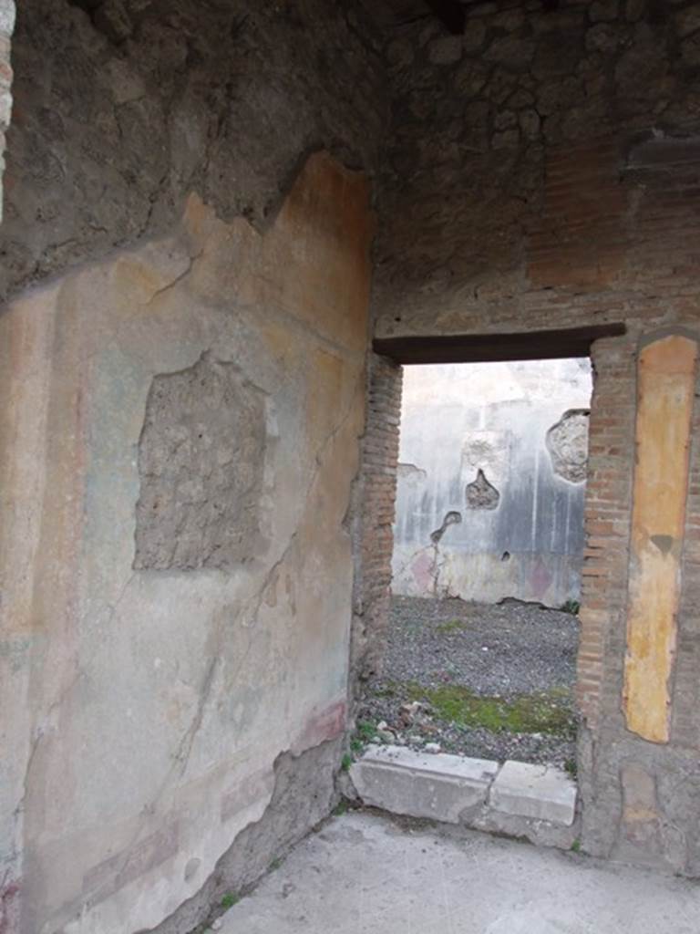 IX.1.22 Pompeii. December 2007. Room 7, tablinum, west wall and doorway with one step to room 10 in north-west corner. 
According to BdI, in the middle of the side walls, on a blue background, were two paintings.
The one that was found on the right (east wall) was almost entirely destroyed, only a fragment of a group of cupid and Pan was preserved. The painting on the left (west) wall represented Hermaphrodite and Silenus. See BdI, 1867, (p.48)
According to Bragantini, the painting of Hermaphrodite and Silenus was found on the east wall.
See Bragantini, de Vos, Badoni, 1986. Pitture e Pavimenti di Pompei, Parte 3. Rome: ICCD. (p.401, tablinum ‘h’)
