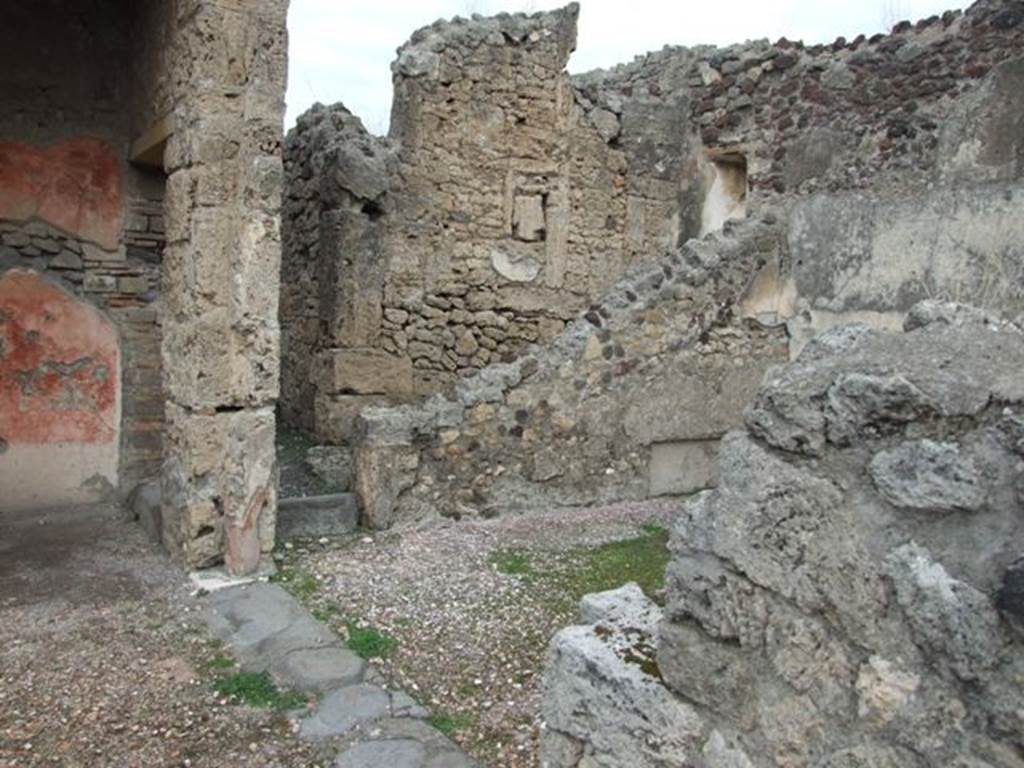IX.1.22 Pompeii. December 2007. Room 13, exedra on east side of first peristyle, looking north. In the north wall was the recess for the couch. The rear wall of the stairs can be seen, leading up to the upper floor.
