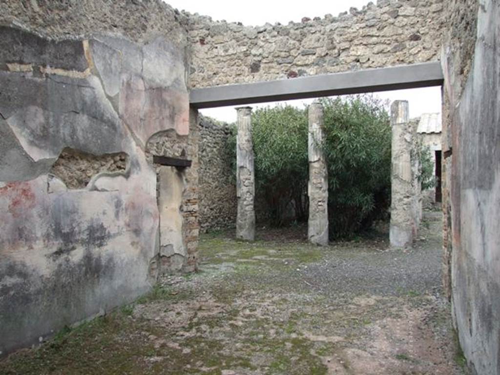 IX.1.22 Pompeii. December 2007. Room 21, looking north to second peristyle. The zoccolo/plinth would have been painted black, the side panels of the middle zone would have been red.
