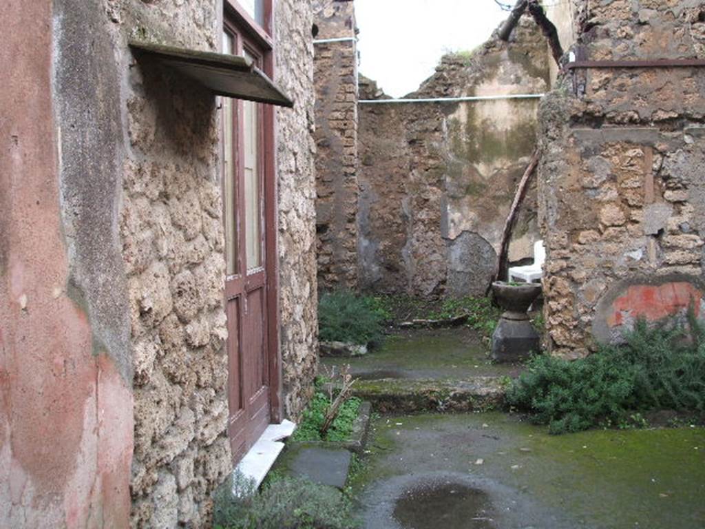 IX.1.26 Pompeii. December 2004. Looking north from entrance corridor across atrium.
On the left would have been a cubiculum and also the triclinium, where the graffito
SODOM(A)  GOMORA  [CIL IV 4976] was found.  
It was inscribed in large letters in charcoal on the wall.
See Cooley, A. and M.G.L., 2004. Pompeii : A Sourcebook. London : Routledge. (p.110)
See Varone, A., 2002. Erotica Pompeiana: Love Inscriptions on the Walls of Pompeii, Rome: Lerma di Bretschneider. (p.141)
See Dobbins, J & Foss, P., 2008. The World of Pompeii. New York: Routledge. (p.195)
According to Mau, the inscription SODOMA
                                                                GOMORA
was found in a triclinium on the left side of the atrium, on the left wall.
See Mau in BdI, 1885, (p.97)
In the centre of the photo is the site of the kitchen and steps to upper floor. According to Boyce, in the kitchen was a lararium painting,but when excavated only the two serpents beside an altar remained.
See Boyce G. K., 1937. Corpus of the Lararia of Pompeii. Rome: MAAR 14. (p.80)
See Pappalardo, U., 2001. La Descrizione di Pompei per Giuseppe Fiorelli (1875). Napoli: Massa Editore. (p.140)
See Sogliano, A., 1879. Le pitture murali campane scoverte negli anni 1867-79. Napoli: (p.18, no.52)
