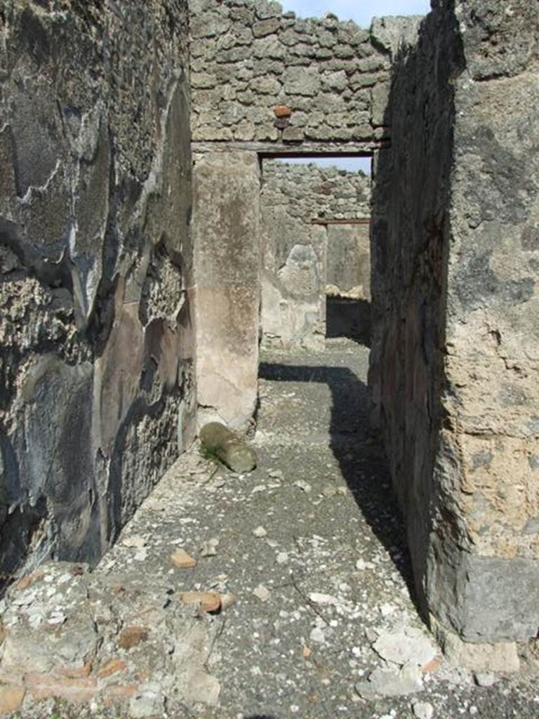 IX.2.18 Pompeii. March 2009. Room 13, corridor to atrium. The remains of the lower masonry steps (in the lower left) would have lead to the rooms on the upper floor via a wooden staircase. The line of the stairs can be seen in the remaining plaster of the left wall.