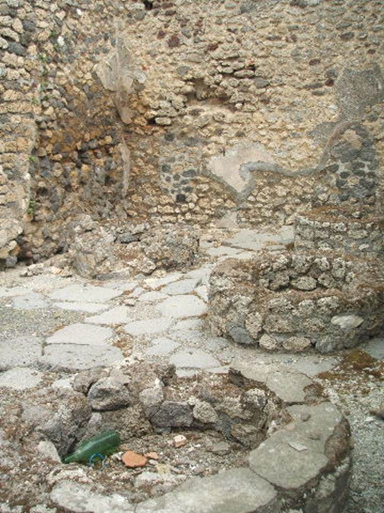 IX.3.12 Pompeii.  May 2005.  Remains of mills on south side of oven.