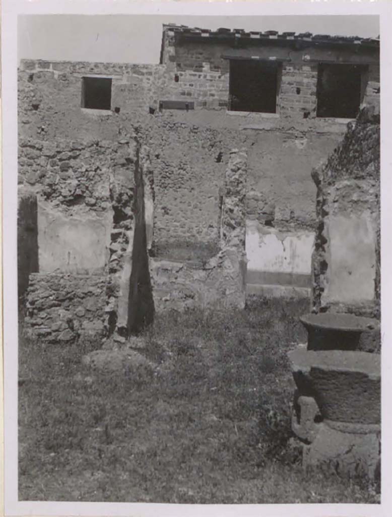 IX.3.12 Pompeii. Pre-1943. Looking north to steps to raised garden area.
According to Warscher, the smallest window would have been from the ala of IX.3.5, the two larger ones next to each other would have been in the south wall of the triclinium in IX.3.5. 
It would seem that the windows have been reconstructed. 
(La fotografia era presa dal pistrino IX.3.10/12. 
La finestra pi piccola a sinistra era quella dellala di IX.3.5, due pi grandi  luna accanto allaltra sono quelli del triclinio (nella parete sud di questultimo).
Sembra che le finestre siano state ricostruite regolarmente.)
See Warscher, T. 1942. Catalogo illustrato degli affreschi del Museo Nazionale di Napoli. Sala LXXXII. Vol.4. Rome, Swedish Institute.
