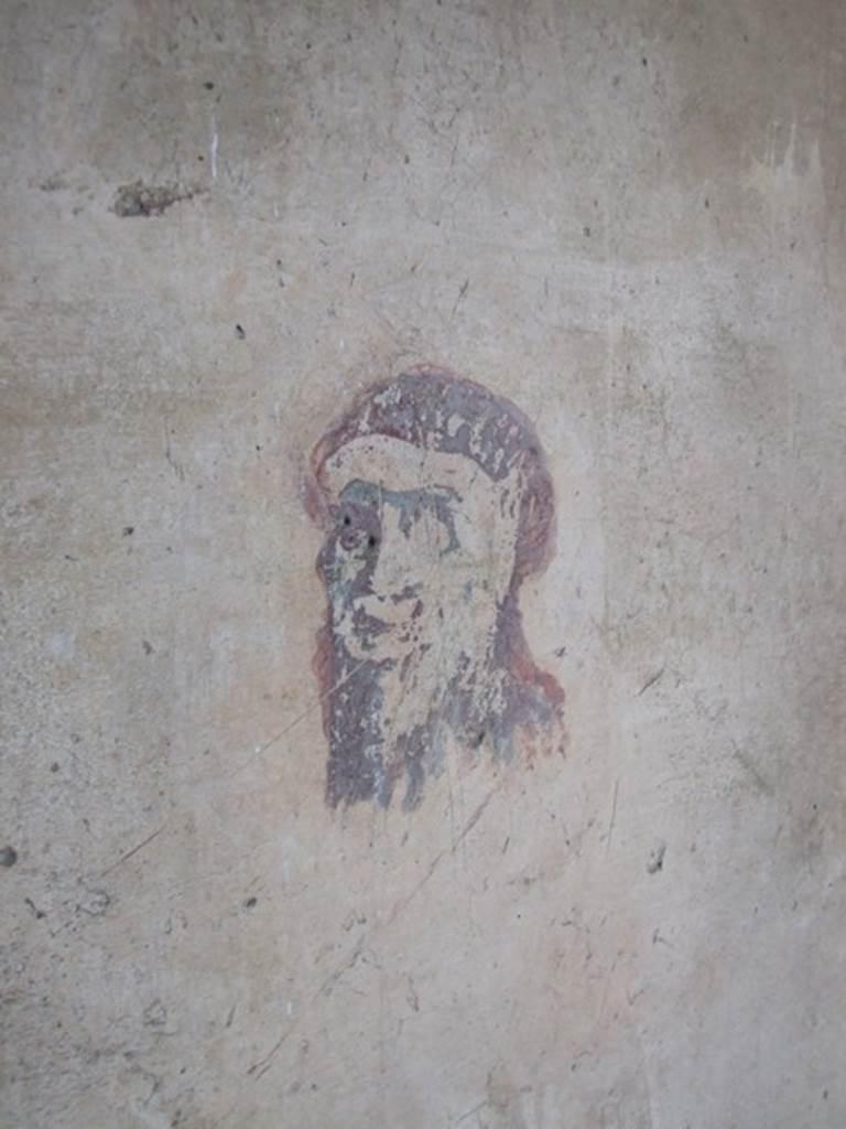 IX.5.6 Pompeii. December 2007. Room 8, wall painting of a head or mask in corridor on east side of tablinum.