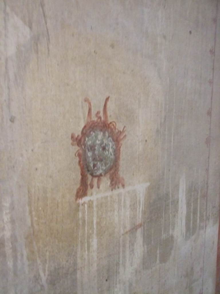 IX.5.6 Pompeii. December 2007.
Room k’, wall painting of a head or mask from south end in corridor on west wall.