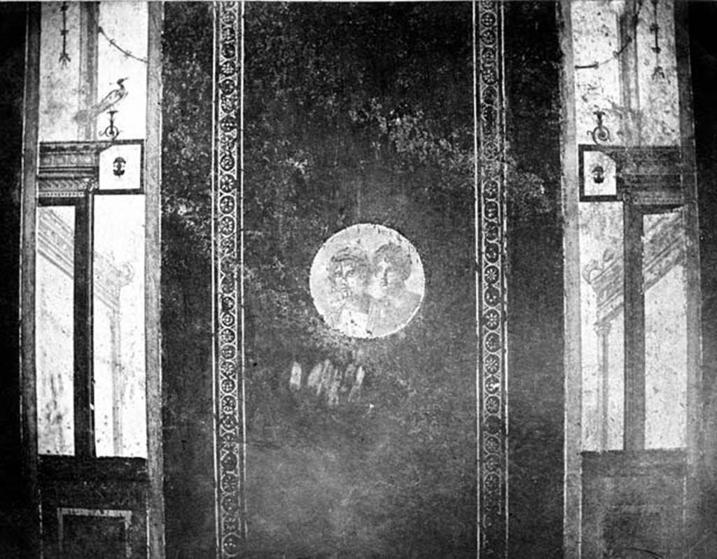 IX.5.11 Pompeii. W.379. Room 8, south wall. Wall decoration from the central panel of the south wall of the ala. 
The panel contained a border around a medallion of the head of a male and female.
On either side of the panel were architectural designs, topped by a bird on the left.
Photo by Tatiana Warscher. Photo  Deutsches Archologisches Institut, Abteilung Rom, Arkiv. 
See http://arachne.uni-koeln.de/item/marbilderbestand/230996 
