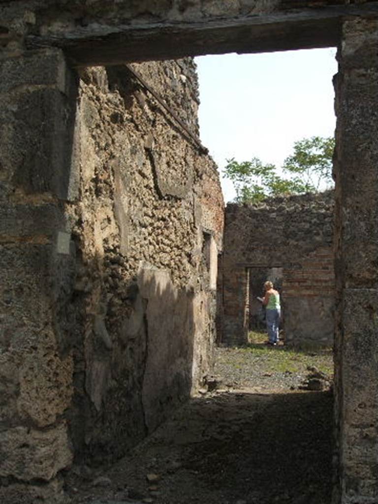 IX.6.3 Pompeii. May 2005. Entrance doorway and corridor.
According to Della Corte, a finger ring found in this house had the initials P.F.L.
See Della Corte, M., 1965. Case ed Abitanti di Pompei. Napoli: Fausto Fiorentino. (p.165, S.40)
According to Giacobello, the initials were on a bronze lamp, identified in a cubiculum of the house.
See Giacobello, F., 2008. Larari Pompeiani: Iconografia e culto dei Lari in ambito domestico. Milano: LED Edizioni. (p.209).
According to Mau The fauces/ entrance corridor was immediately closed from the road by a door with two shutters: preserved in the lava threshold/sill was one of the hinges, and there you could see the square hole where the other hinge was embedded, and the hollows for the four bolts, which were larger than they were at the end of each shutter.
Next to the door were the antepagmenta/door-frame, as could be verified by the grooves in the threshold. At the corners between the fauces and the atrium are embedded in the floor two lava stones, which, however, I don't think would have supported a second door, as was supposed by Sogliano in Notizie, 1879. The ceiling of the fauces was supported by four beams placed lengthwise.
Mau in BdI, 1880, p.197-8
Notizie degli Scavi, 1879, p.20