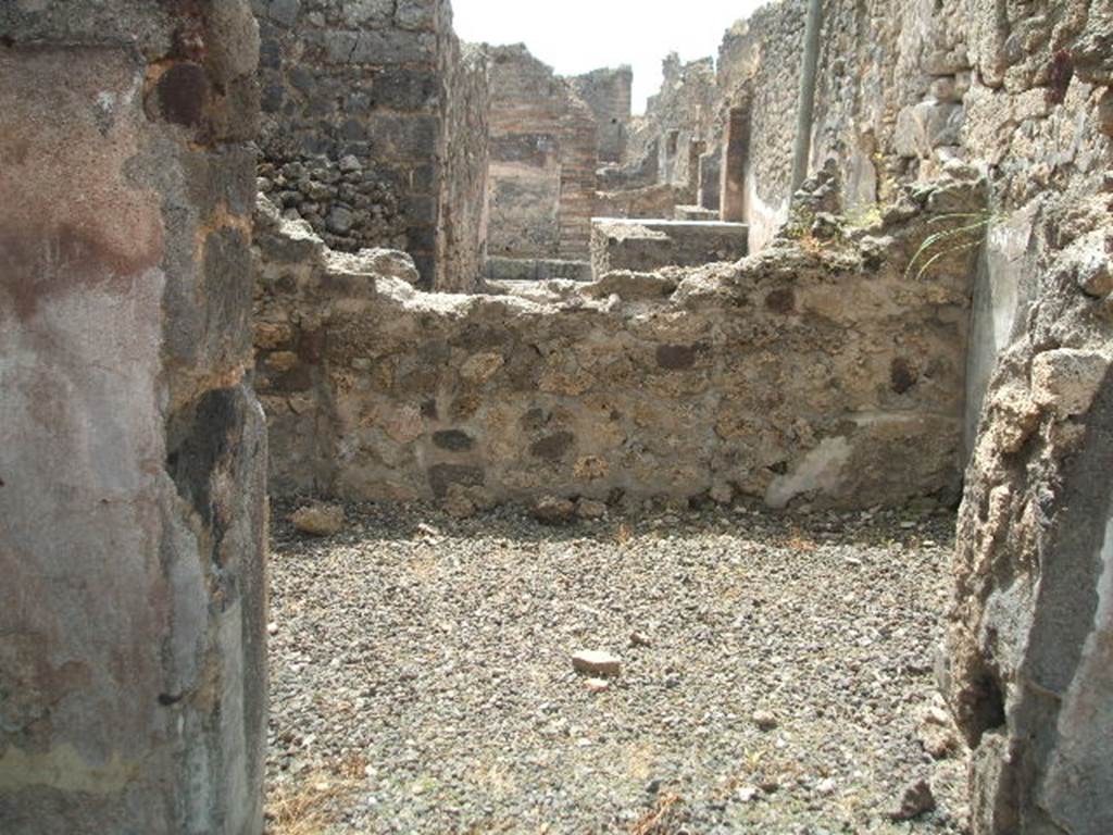 IX.6.3 Pompeii. May 2005. Looking south across room “h” (into rear of IX.6.b), on south side of atrium. According to Mau, this room was found with a wooden threshold and white plaster on its walls. Seen on the extreme left of the rear wall, was the usual recess for the short side of the bed which would have been against the left wall. In fact, in this part, the rough floor was a little better preserved.