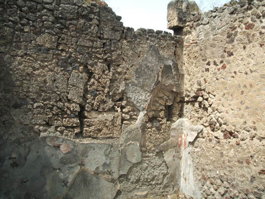 IX.6.5 Pompeii. May 2005. Room in south-west corner of peristyle, triclinium. Eschebach identified the exedra (triclinium) onto the garden, as being on the right hand side of the tablinum. See Eschebach, L., 1993. Gebäudeverzeichnis und Stadtplan der antiken Stadt Pompeji. Köln: Böhlau. (p.427)  According to Della Corte, found in the triclinium against the skeleton of a fugitive, were silver and bronze coins, a golden ring and three statues of Penates, together with nine bronze bracelets.
See Della Corte, M., 1965.  Case ed Abitanti di Pompei. Napoli: Fausto Fiorentino. (p.163)  According to Boyce, in the south-east corner of the south portico of the peristyle were found numerous objects.  They included vases, lamps, jewellery, and also three bronze statuettes –
Mercury, holding his purse in his right hand, and caduceus in his left –
Two Lares, each with patera and rhyton.
He gave the reference as Not.Scavi, 1878, 372.
See Boyce G. K., 1937. Corpus of the Lararia of Pompeii. Rome: MAAR 14. (p.86-7) 
These objects, found in the house, can be seen in the guide to the”Tales from an Eruption” exhibition, edited by Prof. P. G. Guzzo, Milan: Electa, (pp.113-115).  These are now held in Naples Archaeological Museum -
Octagonal bronze inkpot, Inventory number 115614
Bronze bracelets with big green glass paste stone as fastening, Inventory number 118270-71
Bronze statuettes of Lares, Inventory number 115555-56
Bronze statuette of Mercury, with Petasus and Caduceus and bag, Inventory number 115554.


