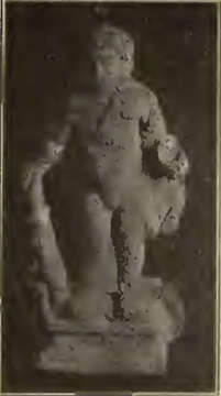 IX.7.11 Pompeii.
Discovered 1912 to the left of the entrance at a depth from 1.70m down to the threshold level.
Bronze statuette of a naked cupid with the attributes of Hercules, standing on a rectangular base, resting his right hand on a club, gripping a skyphos with his left hand, with the lion skin on his left shoulder.
See Notizie degli Scavi di Antichità, 1912, p.333-336, fig 3.