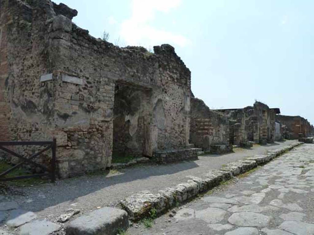 IX.8.7 Pompeii. May 2010. Entrance on south side of Via di Nola, looking west. 
On the west (right) side of the entrance doorway, between IX.8.7 and 6, (centre of photo) were found 
(A.) Rustius (Verus) (rogat)  [CIL IV 3750]
(A.) Rustius (Verus) facit      [CIL IV 3751]
And a third written at the side of number 3 read - (A.) Rustius (Verus) facit     [CIL IV 3738 with Note 4]
See Della Corte, M., 1965.  Case ed Abitanti di Pompei. Napoli: Fausto Fiorentino. (p.133)  
According to Epigraphik-Datenbank Clauss/Slaby (See www.manfredclauss.de), these read as 
M(arcum) Licinium Faus 
/tinu[m]
aed(ilem) v(iis) a(edibus) s(acris) p(ublicis) p(rocurandis) v(irum) b(onum) d(ignum) r(ei) [p(ublicae) o(ro)] v(os) f(aciatis) Rustius rog(at)    [CIL IV 3750]

C(aium) Calventium Sittium
/IIv(i)r(um)
Rustius facit OMLVS idem facit      [CIL IV 3751]

L(ucium) Popidium Secundum
aed(ilem) o(ro) v(os) f(aciatis) Fustius faci ,<t=I> scrib[it      [CIL IV 3738]

Also found were the following recommendations from the neighbours. 
Ti. Claudium Verum, II virum   
vicini rogant         [CIL IV 367]

Ti. Claudium Verum  
vicini rog(ant)      [CIL IV 440]

They prove the nearness of the house of this magistrate, but cannot identify it precisely.  Mau thought it was definitely the House of the Centenario because of the graffiti found on the middle column on the south side of the peristyle.
This named - Ti(berius) Claudius Ver(us)      [CIL IV 5229]

Also found on the faade, between the entrances of numbers IX.8.7 and 6, was the electoral programme -
Rustium Verum d.i.d
(Ti. Claudi) Vere, fac qui te fecit      [CIL IV 3760 with Note 2]
See Della Corte, M., 1965.  Case ed Abitanti di Pompei. Napoli: Fausto Fiorentino. (p.131)  
According to Epigraphik-Datenbank Clauss/Slaby (See www.manfredclauss.de), this read as 
Rustium Verum d(uumvirum) i(ure) d(icundo) 
/ vere
fac qui te fe[cit]       [CIL IV 3760]
